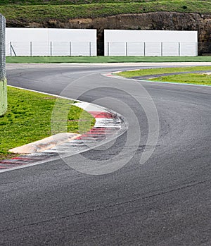Double turn chicane track motor sport circuit with white banner copy space in background