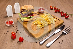 Double veal cheeseburger a wooden board. ketchup