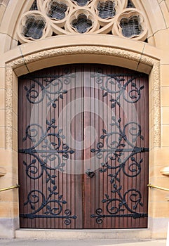 Double wooden church doors set in sandstone archway