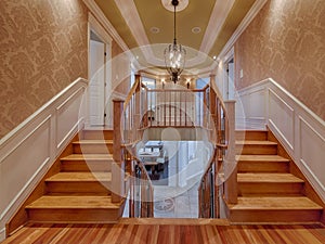 Double wooden staircases in luxury house photo