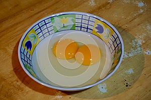 Double yolk egg on a small plastic bowl