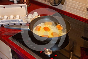 Double yolk, strange two yolks in one hen lucky egg frying sunny-side up in a cast iron pan on the stove
