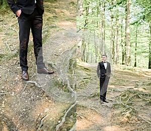 Doubled picture of stylish groom posing in the wood