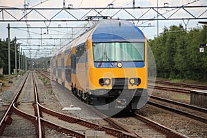 Doubledeck commuter train at station `t harde in the Netherlands