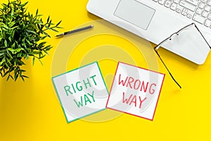 Doubt concept.. Right and wrong way icons on work desk from above