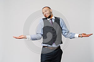Doubt concept - Young african american businessman wearing tie and over light grey background clueless and confused