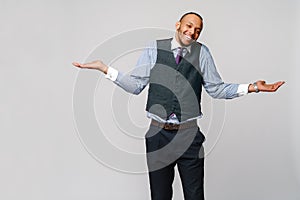 Doubt concept - Young african american businessman wearing tie and over light grey background clueless and confused