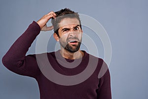 Doubt, confused and portrait of man with puzzled, uncertain and scratch head on gray background. Thinking, mockup space