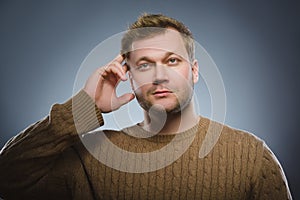 Doubt, expression and people concept - man thinking over gray background