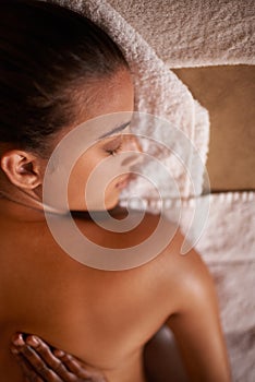 When in doubt massage it out...a young woman enjoying a relaxing massage at the day spa.