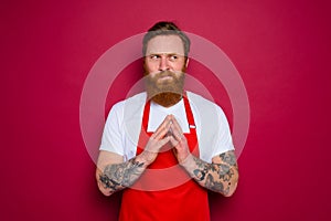 doubter isolated chef with beard and red apron