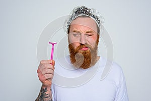 doubter man wants to adjust the beard with a razor blade