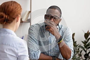 Doubtful african hr talking to caucasian applicant at job interview photo