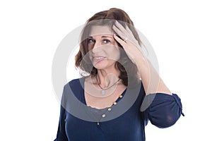 Doubtful and pensive mature woman in blue isolated on white.