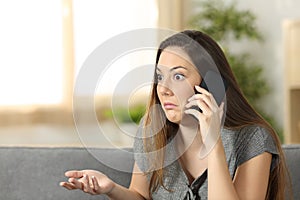 Doubtful woman listening a phone call