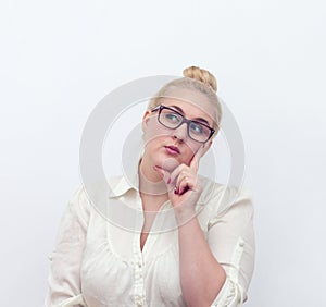 Doubtful young woman thinking, on white