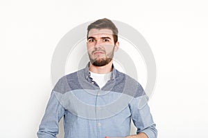 Doubting man looking at camera, isolated