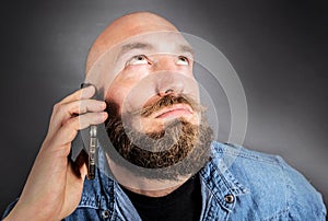 Doubting man speaking on the phone