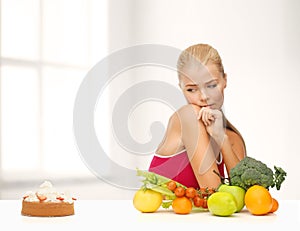 Doubting woman with fruits and pie