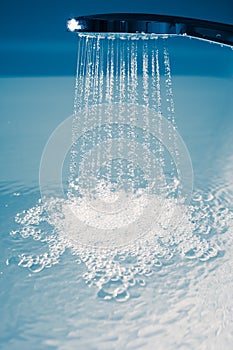 Douche filling a bathtub with water stream