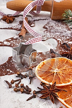 Dough for Christmas cookies, spice and ingredient for baking gingerbread on old rustic board