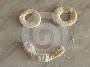 Dough for donuts that smile. Rolled Dough for donuts. Cutting from fresh dough for traditionally donuts.