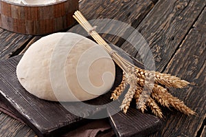 Dough with ears of wheat closeup