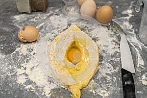 dough flour eggs oil laid out on the kitchen table to prepare khachapuri in Ajax.