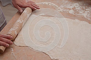 Dough, flour, rolling pin on the table top view