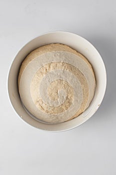 proofed dough in a white bowl