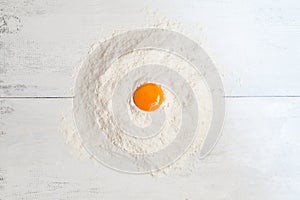 Dough ingredients on white table. Egg yolk and