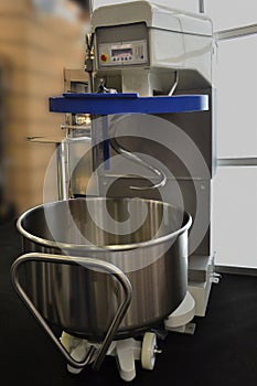 Dough mixing machine with movable bowl