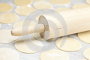 Dough and rolling pin with flour on the table