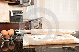 Dough and rolling pin in kitchen