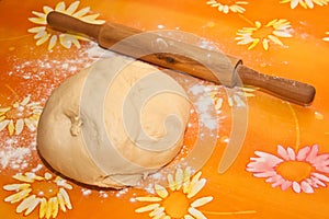 Dough and rolling pin on the table