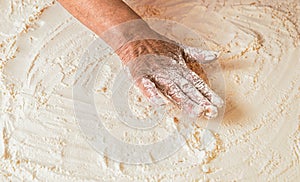 Dough on white powder covered table. Hand flour. Hands baker with flour in kitchen. Hands woman covered in flours