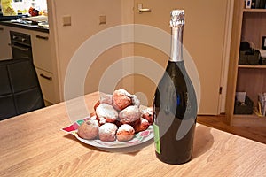 Doughnut balls prinkled with powdered sugar and Champagne