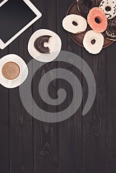 Doughnuts, coffee and digital tablet