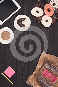 Doughnuts, coffee and digital tablet