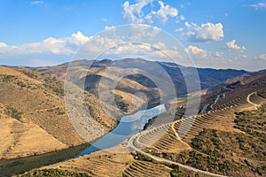 The Douro valley with its river and its vineyards cultivated in terraces on the mountainsides. Superb cloudy sky reflected in the