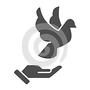 Dove on hand solid icon, world peace day concept, flying pigeon and human palm sign on white background, person hand and