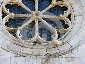 Dove resting on old rose window of romanesque church valdicaste