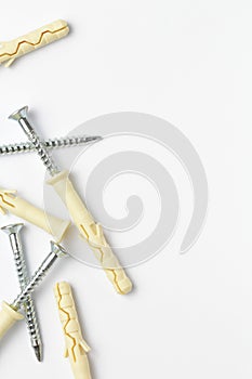 Dowels, screws, white background, place for text, flat layer, close-up