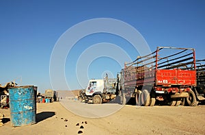 A truck stop with local vehicles in Dowlatyar, Ghor Province, Afghanistan photo