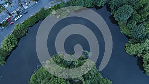Down aerial shot over West Point, hairpin meander in River Mersey surrounded by lush plants
