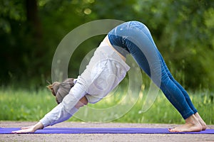 Down dog pose in park alley