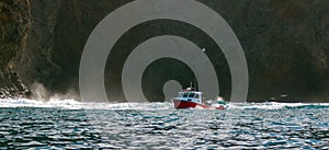 Down east style lobster boat at Coche Point off the coast of Santa Cruz Island in the Channel Islands off the California coast USA photo