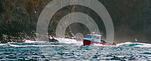 Down east style lobster boat at Coche Point off the coast of Santa Cruz Island in the Channel Islands off the California coast USA photo