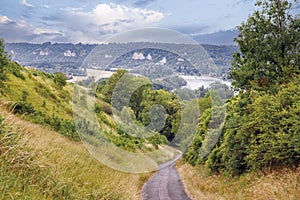 Down hill road with beautiful view to the mountains and river Seine in Les Andelys, France.