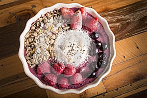 down medium shot of healthy smoothie bowl with wooden background